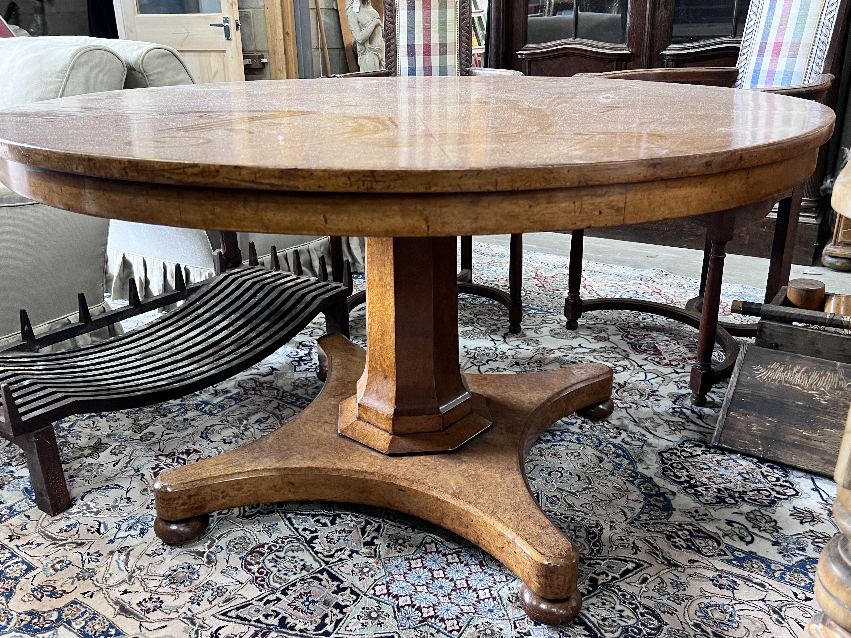 An early Victorian circular bird's eye maple circular breakfast table, with a segmented veneered top, diameter 128cm, height 74cm